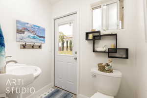 Bathroom featuring toilet and baseboards