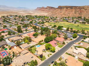 Aerial perspective of suburban area featuring a mountain backdrop