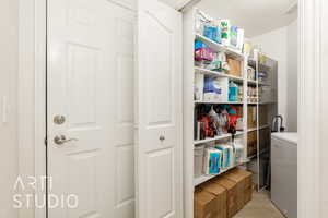 Storage area featuring washer / dryer