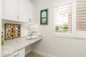 Interior space with baseboards and built in study area