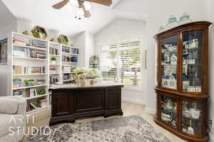 Office space with a ceiling fan, light wood-type flooring, and vaulted ceiling