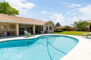 View of swimming pool featuring a lawn, a patio area, and a ceiling fan