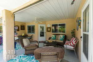 View of patio / terrace featuring a ceiling fan and an outdoor living space