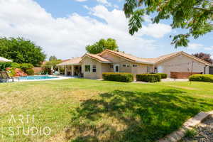 View of front of home with stucco siding, a tile roof, and a patio area