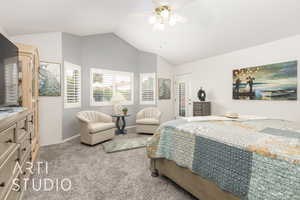 Carpeted bedroom featuring vaulted ceiling and ceiling fan