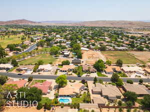 Aerial view of residential area with mountains and a pool area