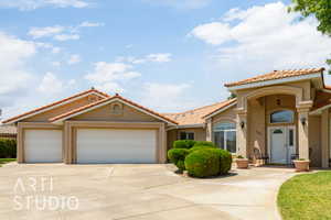 Mediterranean / spanish-style home featuring stucco siding, an attached garage, driveway, and a tile roof