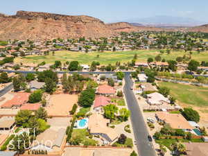 Aerial view of residential area with mountains and a golf club
