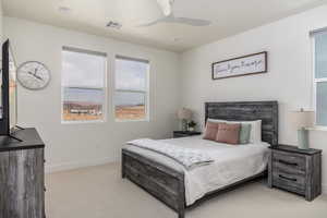 Carpeted bedroom featuring baseboards and a ceiling fan