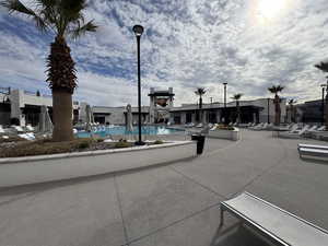 View of community with a swimming pool and a patio area