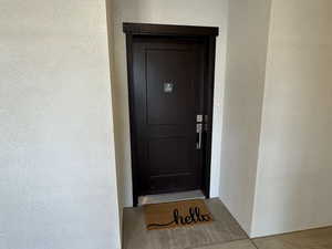 View of exterior entry featuring stucco siding