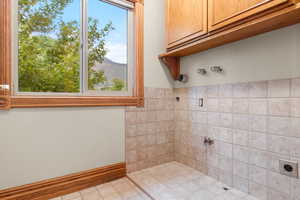 Full bath featuring a mountain view, a tile shower, and tile patterned floors