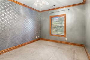 Unfurnished room with crown molding, carpet flooring, wallpapered walls, and ceiling fan