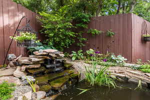 View of yard with a small pond
