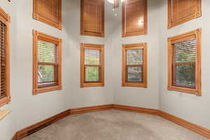 Spare room featuring carpet floors and baseboards
