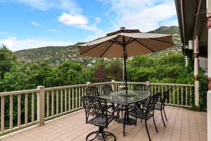 Deck with outdoor dining space and a mountain view