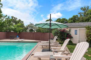 View of swimming pool featuring a patio and a diving board