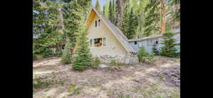 View of side of home with stucco siding and stone siding
