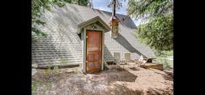 View of front of house featuring a shingled roof