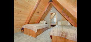 Carpeted bedroom featuring wooden ceiling