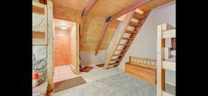 Bathroom with a wood ceiling with exposed beams and tile patterned floors