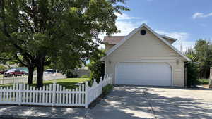 View of side of home featuring driveway and an outbuilding