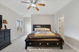Bedroom with access to exterior, light colored carpet, and a ceiling fan