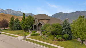 View of front of house with a front lawn and a mountain view