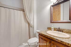 Bathroom with vanity and a shower with shower curtain