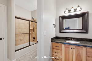 Bathroom with vanity, shower / bathtub combination, and marble finish flooring