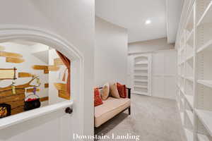 Sitting room featuring light colored carpet