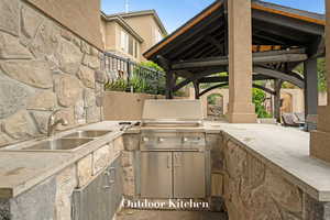 View of patio with a gazebo and an outdoor kitchen
