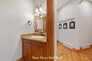 Bathroom with vanity and wood finished floors