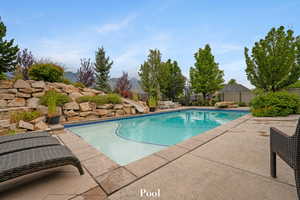 View of swimming pool featuring a water slide and a patio