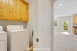 Laundry area with separate washer and dryer, cabinet space, light tile patterned floors, recessed lighting, and light carpet
