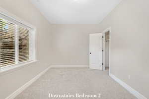 Empty room featuring carpet floors and baseboards