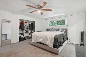 Bedroom with carpet floors, a closet, and a ceiling fan