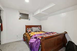 Carpeted bedroom featuring baseboards