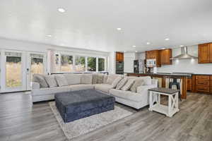Living area with recessed lighting and light wood finished floors