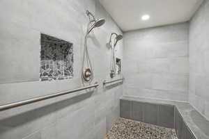 Full bath featuring a tile shower