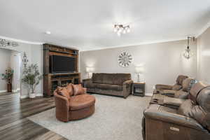 Living area featuring ornamental molding and wood finished floors