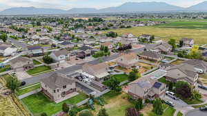 Aerial view of property and surrounding area featuring nearby suburban area