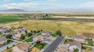 View of rural area with a mountain backdrop, abundant farmland, and nearby suburban area
