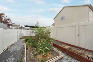 Fenced backyard with a garden