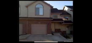 View of front of property with an attached garage and driveway
