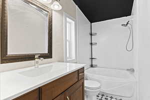 Bathroom with vanity and tub / shower combination
