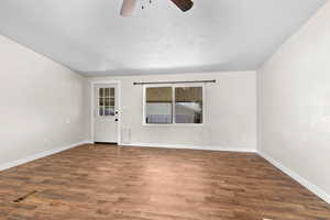Spare room with a ceiling fan and wood finished floors