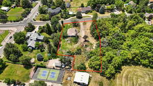 Aerial view of property and surrounding area featuring property boundaries highlighted