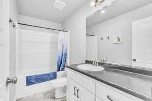 Bathroom featuring vanity and shower / bath combination