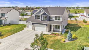 Craftsman-style house featuring driveway, a shingled roof, a residential view, a porch, and a garage
